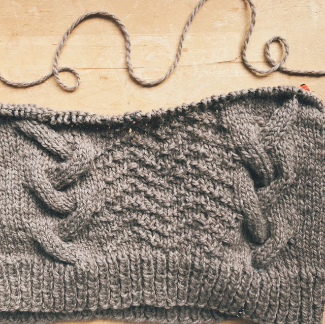 Image of The Edge cabled sweater in progress.