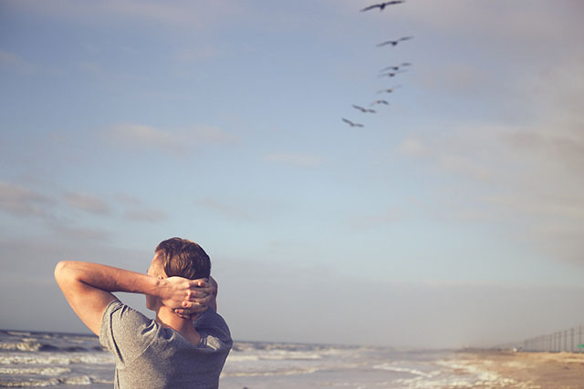 Image of a high school senior staring at the ocean contemplating the future.