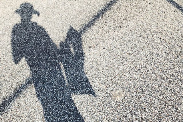 Image of my shadow on the street as i learn to walk and knit at the same time.