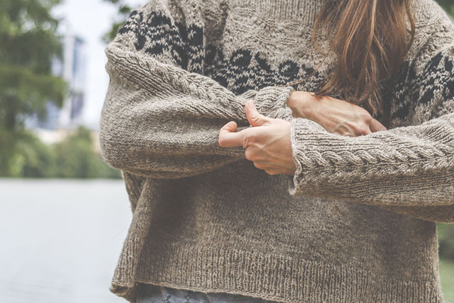 Image of Plum sweater sleeve detail.