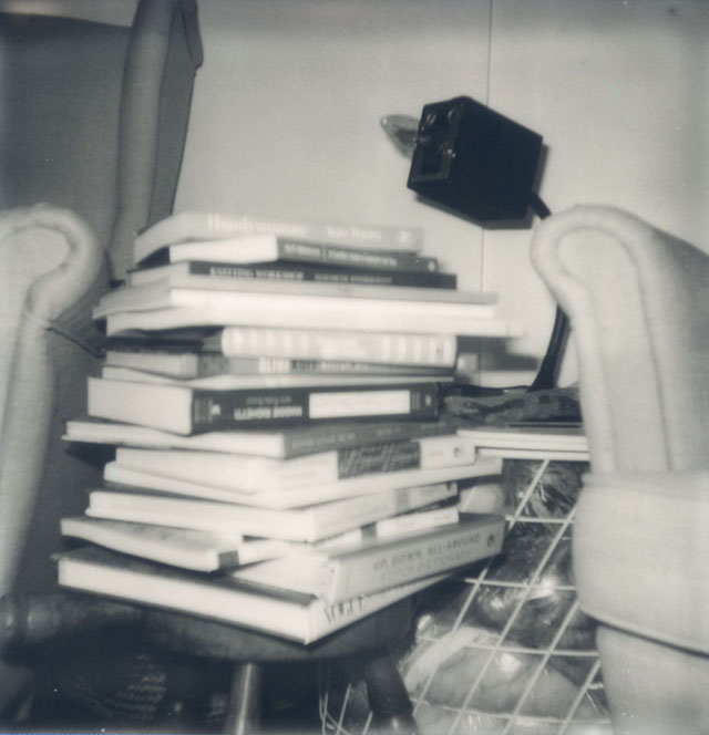 a Polaroid of random books stacked books.