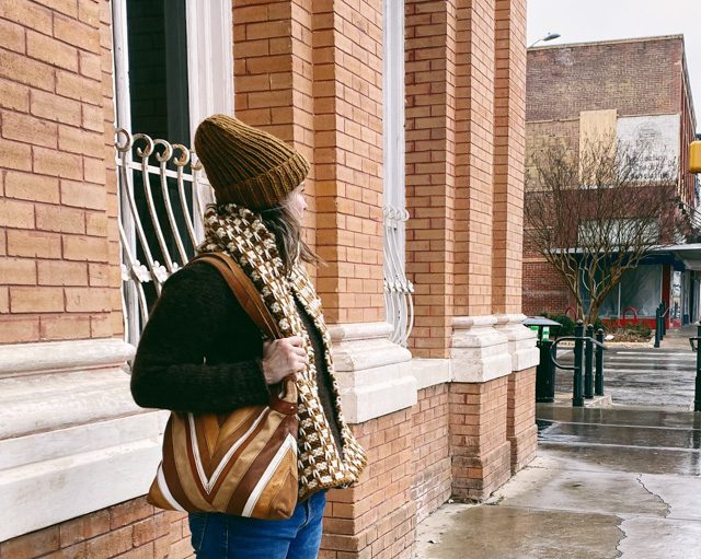 Image of me walking the town square in both my Seafarer's Cap and Graduate Scarf knitting projects.