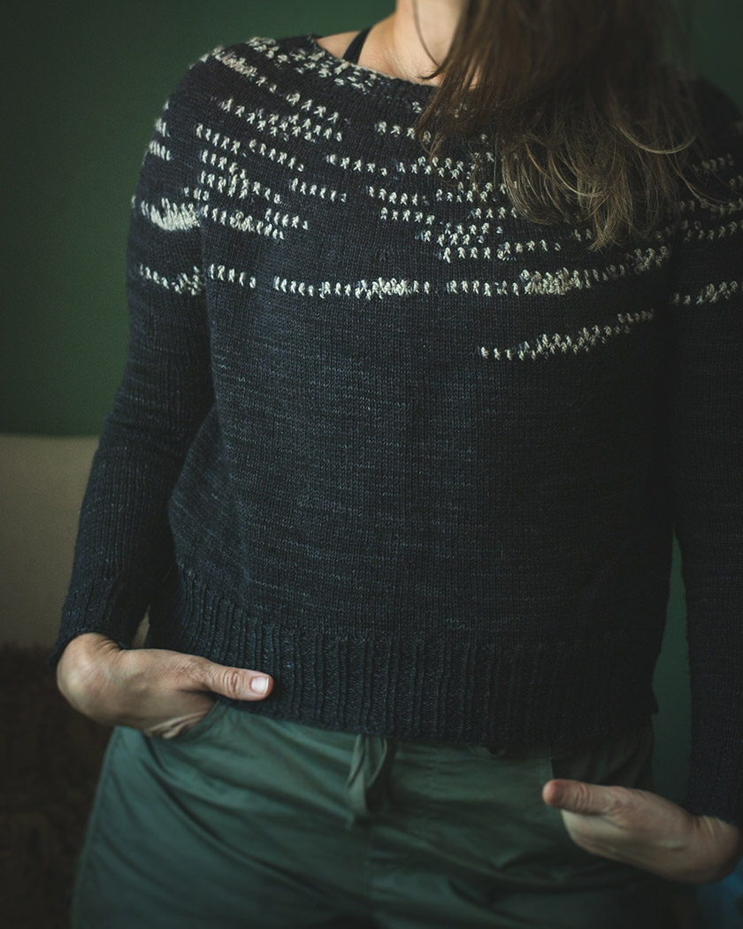 Image of the randomly placed bobble stitches in contrast color on the sweater.