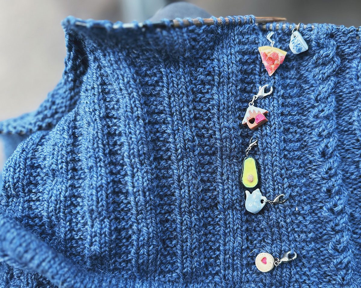 Image of Lately Pullover test knit sweater and food themed stitch markers.