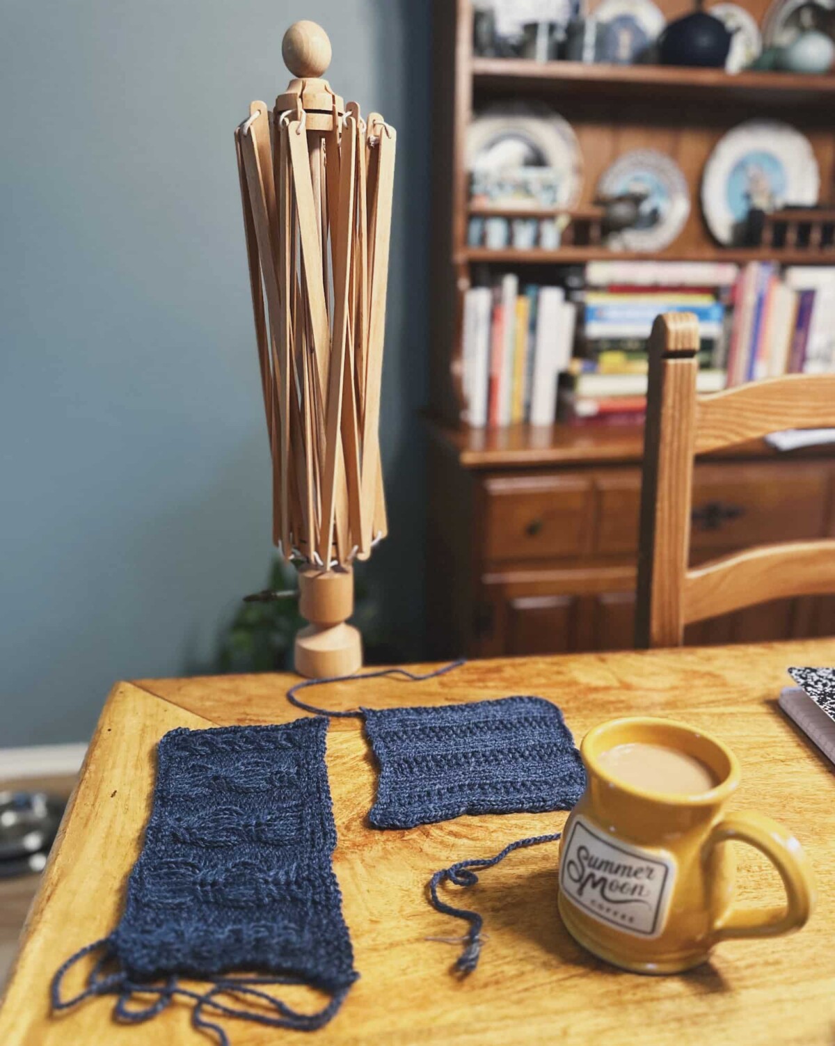 Image of my yarn swift still out on the table with my swatches for the Lately Pullover drying next to it.