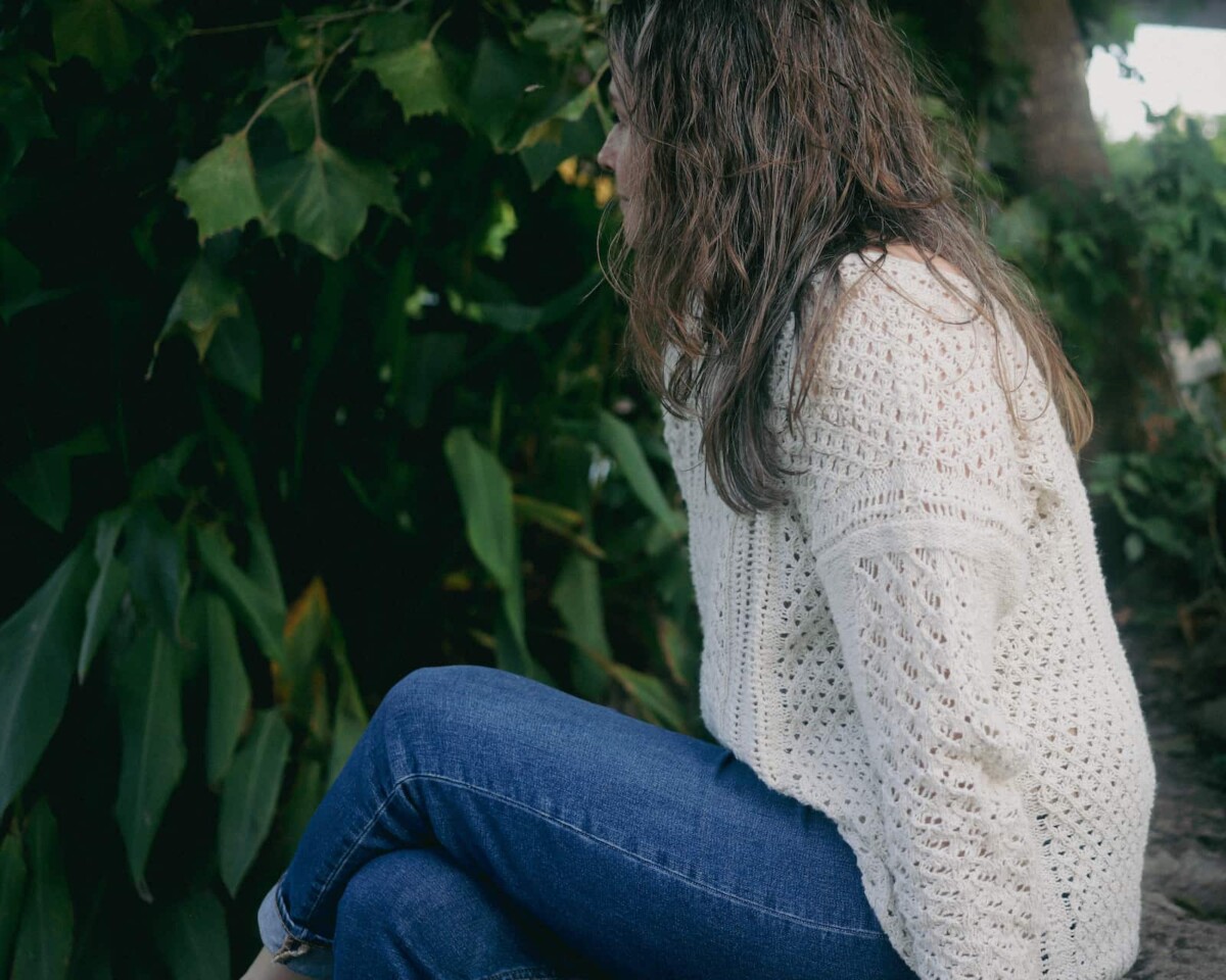 Image of me sitting by the river in my Villanelle.