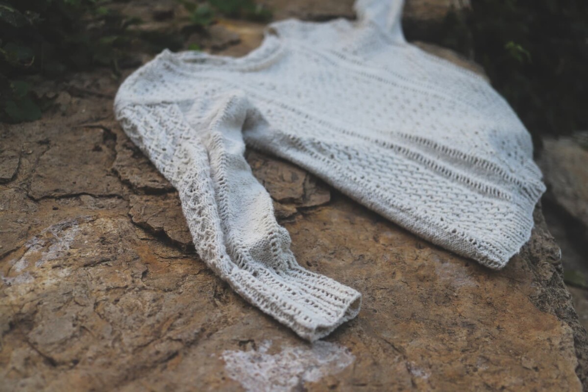 Image of my VIllanelle laying on rocky bank of the river.