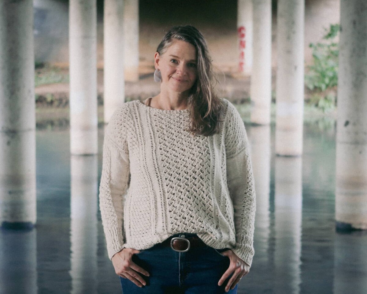 Image of me in my new Villanelle sweater by the riverside.